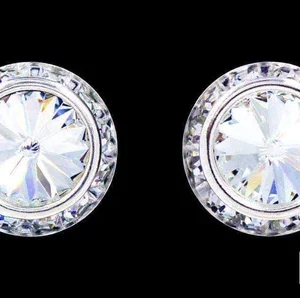 A pair of earrings with a diamond surround.
