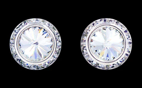 A pair of earrings with white stones on them.