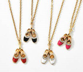 A group of four necklaces with shoes on them.