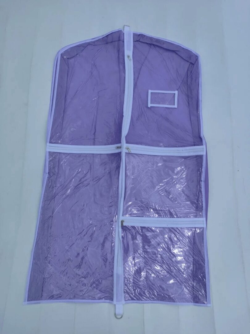 A purple suit bag with a white strip on it.
