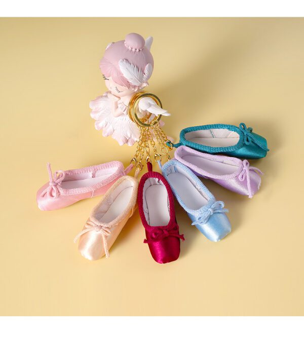 A group of different colored ballet shoes on display.