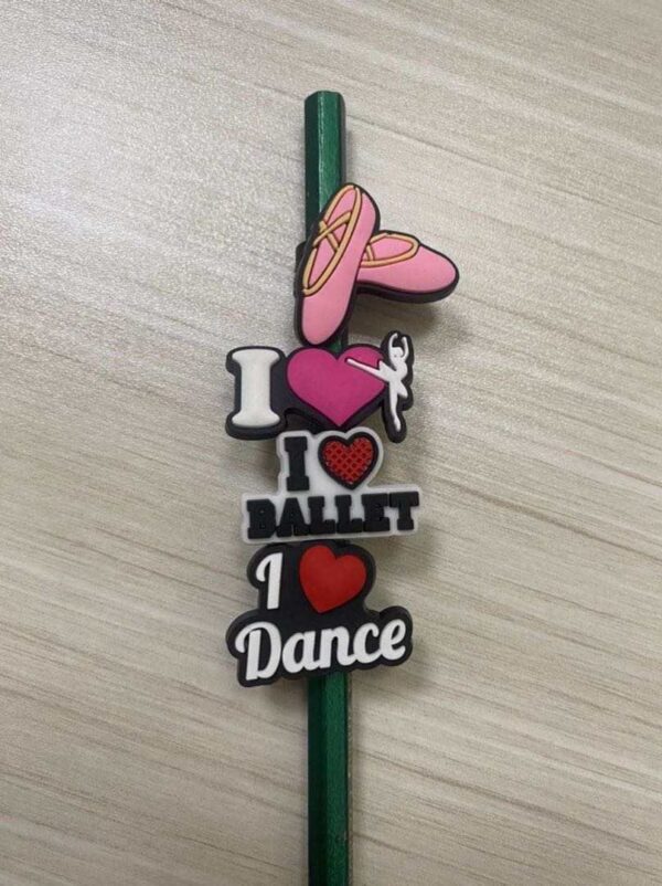 A pencil with magnets on it that say i love ballet, i dance and a pink shoe.