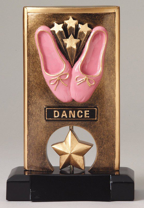 A bronze plaque with pink shoes and a star.