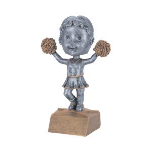 A silver figurine of a cheerleader holding pom poms.