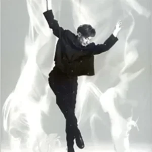 A man in black jacket jumping in air.