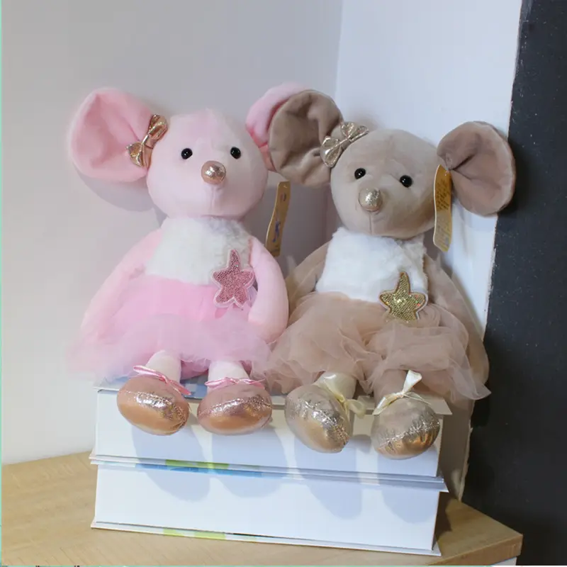 Two stuffed mice are sitting on a box.