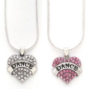 Two heart-shaped dance pendants with rhinestones, one silver and one pink.