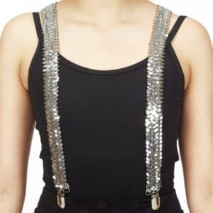 Silver sequin suspenders worn over a black tank top.