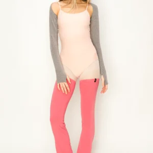 Woman wearing a light pink dress with gray sleeves and bright pink tights.