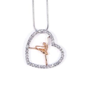 Heart-shaped pendant with a ballet dancer inside on a silver chain.