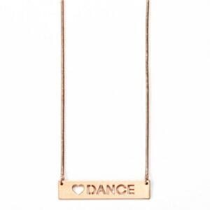 Gold necklace with a rectangular pendant engraved 'DANCE'.