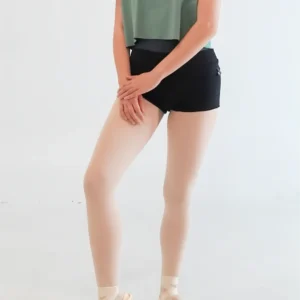 Person standing with legs crossed, wearing black shorts and green top.