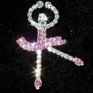 Sparkling ballerina figure made of crystals on a dark background.