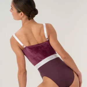 Woman wearing a stylish purple and white swimsuit from the back.