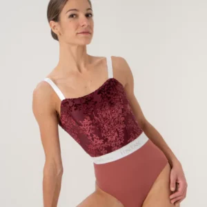Woman wearing a stylish velvet and mesh bodysuit with white straps.