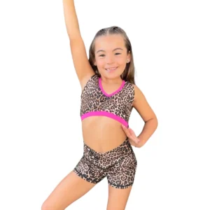 Young girl in leopard print dance outfit posing cheerfully.