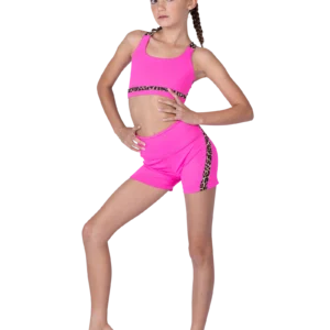 Young girl posing in bright pink athletic wear with silver accents.